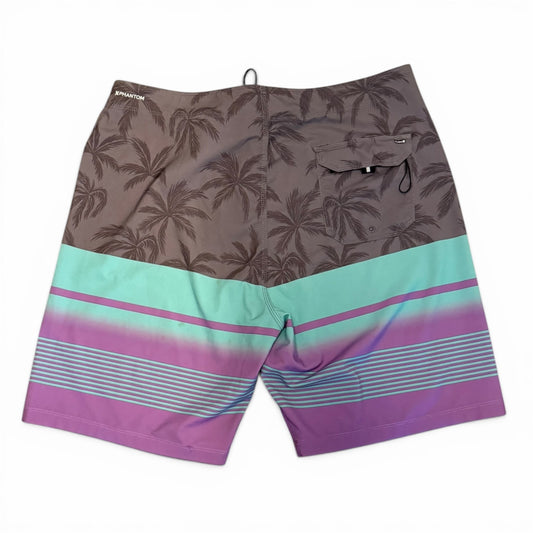 Back of Board shorts with palm tree pattern and colorful stripe on a white background