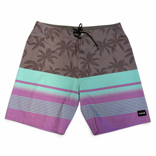 Front of Board shorts with palm tree pattern and colorful stripes on a white background