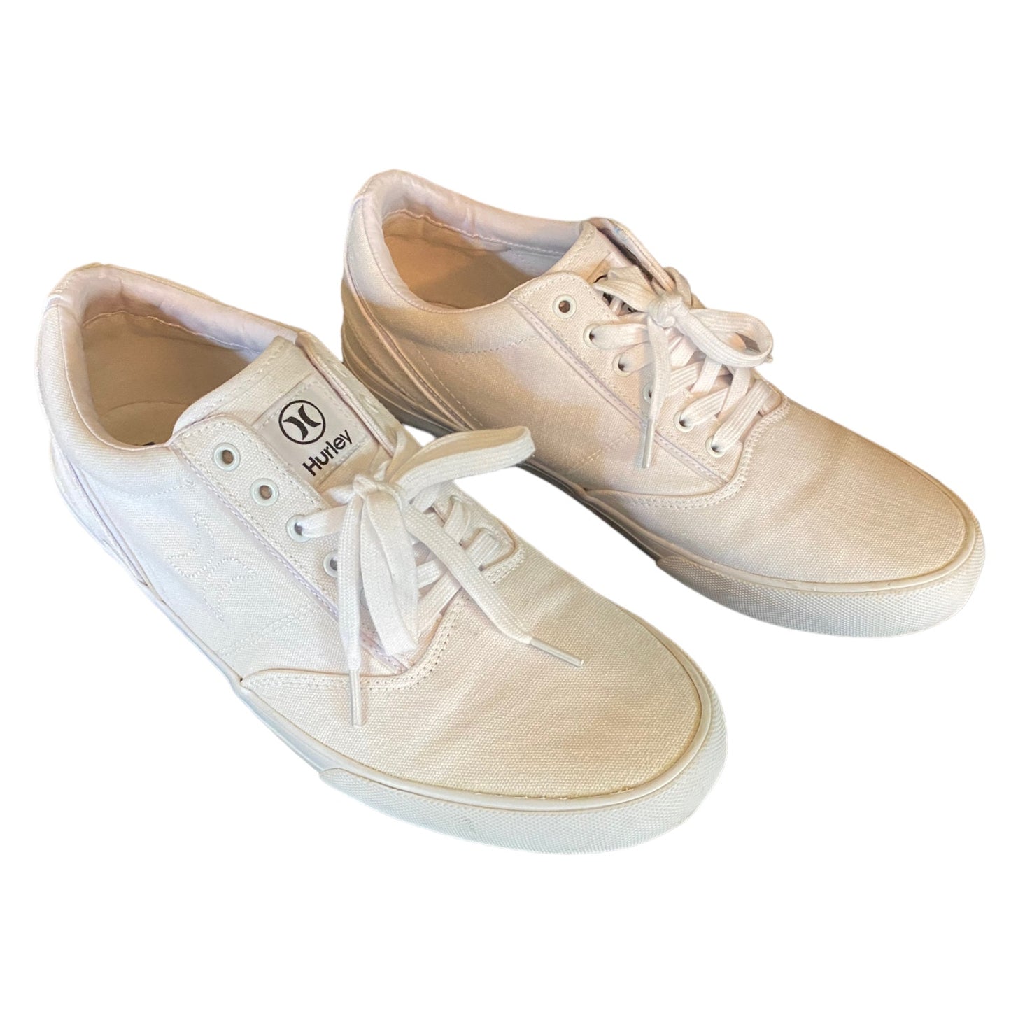 Front side of white sneakers with white laces on a white background