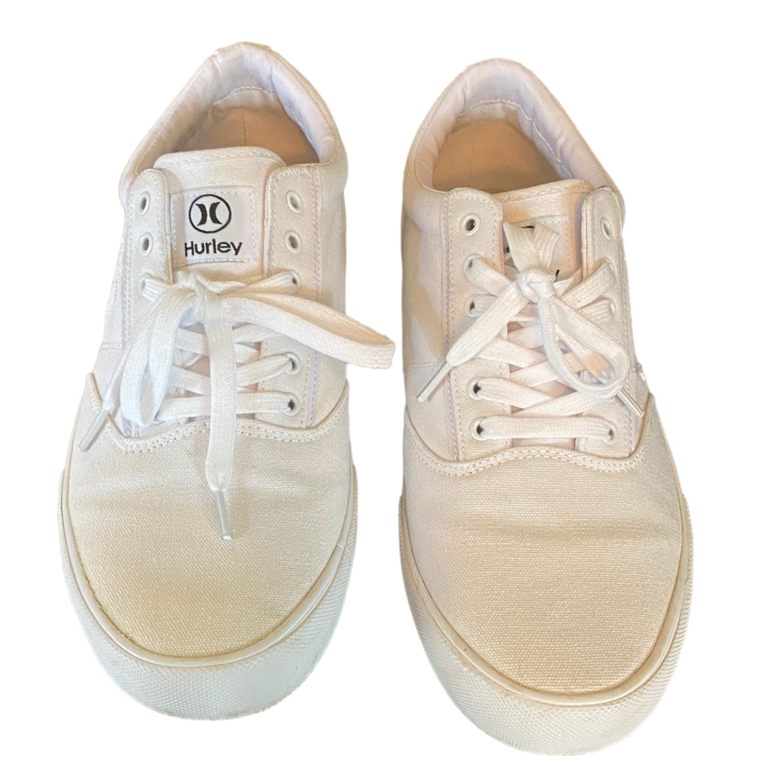 Front of white sneakers with white laces and Hurley logo on a white background