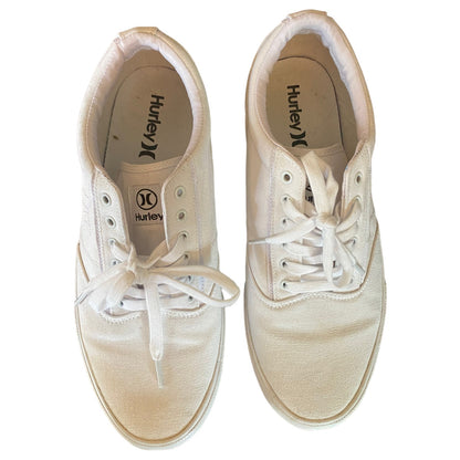 Top of white sneakers with white laces on a white background