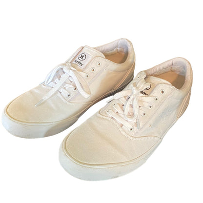 Front side of white sneakers with white laces on a white background
