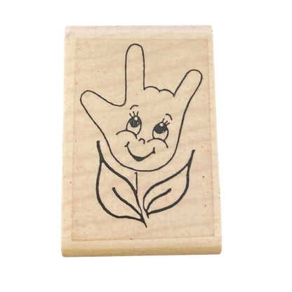 Rubber stamp with a design of a hand and leaf on a white background