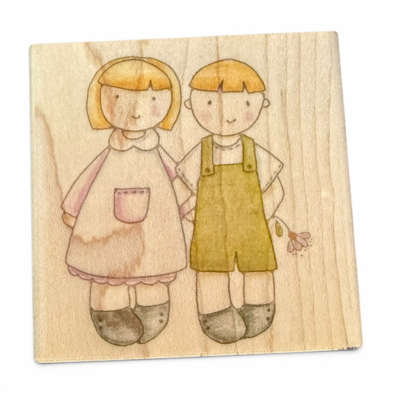 Wooden stamp with illustrations of a girl and a boy on a wooden background