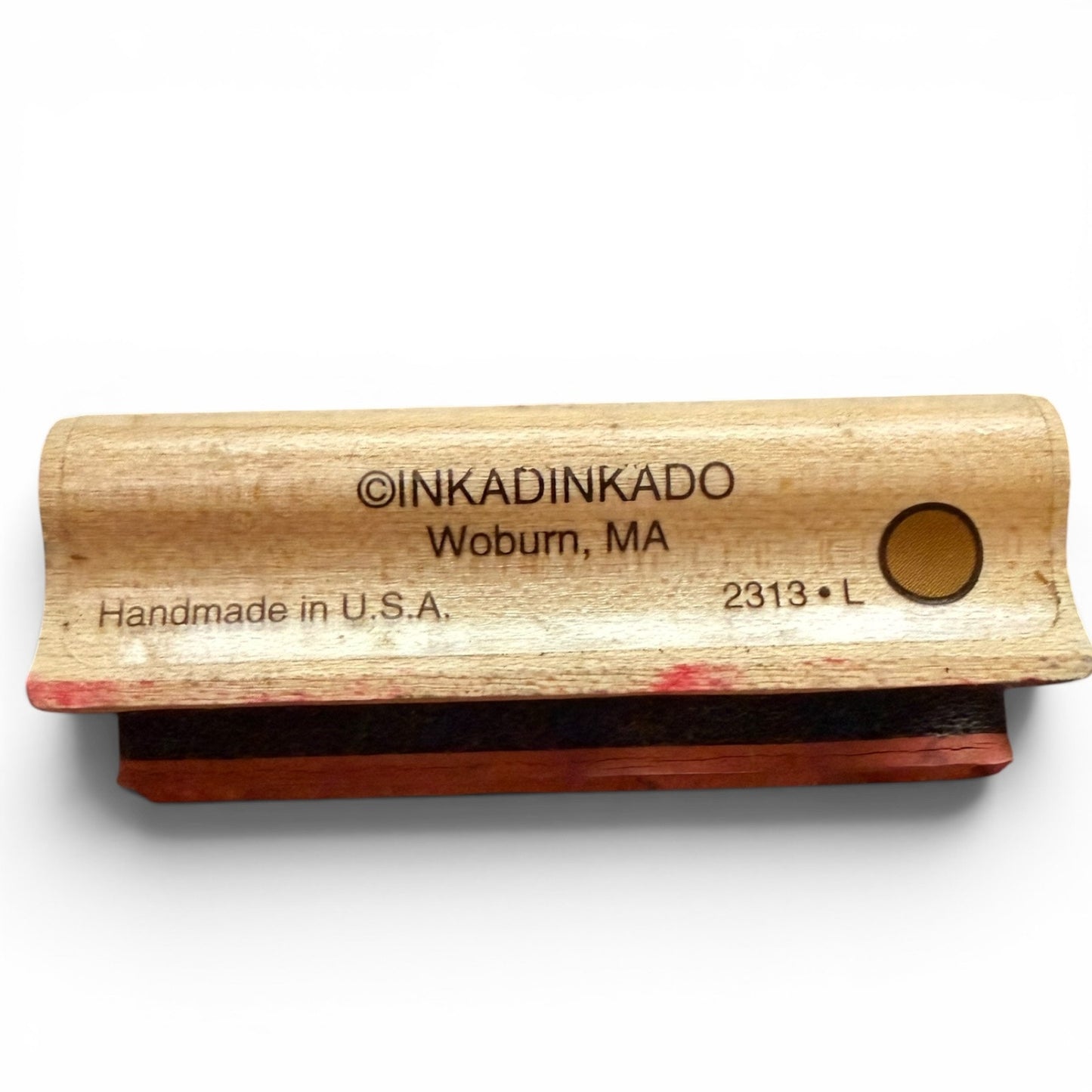 Wooden stamp with red pad and 'INKADINKADO' branding on a white background