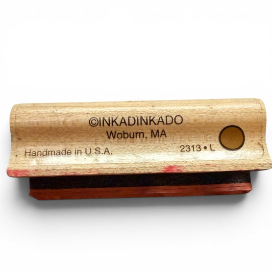 Wooden stamp with red pad and 'INKADINKADO' branding on a white background