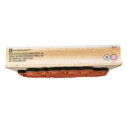 A wooden stamp block, shown from the side on a white background. 