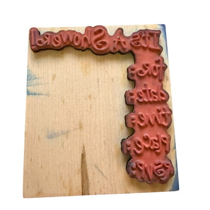 Wooden stamp with carved text on a wooden block