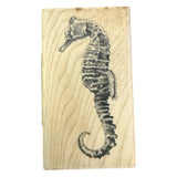 Wooden block with a black seahorse design on a white background