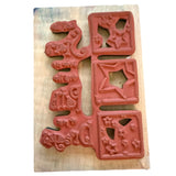 Wooden block with red rubber stamp on a white background