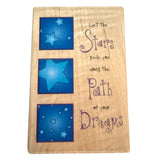 Wooden plaque with blue star designs and motivational text on a white background