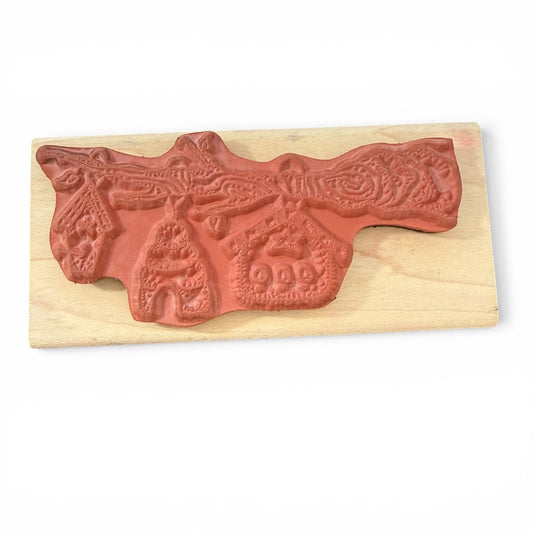 Wooden stamp with decorative design on a white background
