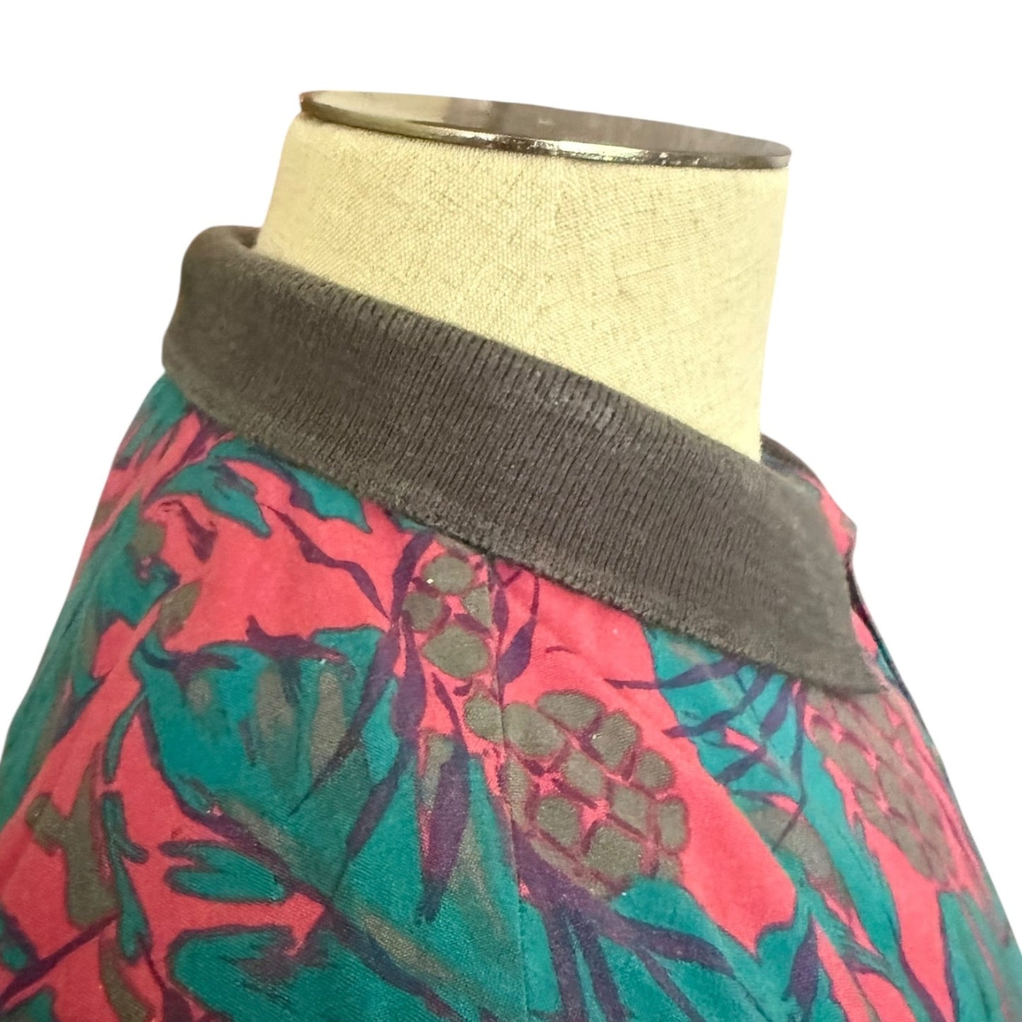 Mannequin wearing a colorful shirt with fading collar on a white background