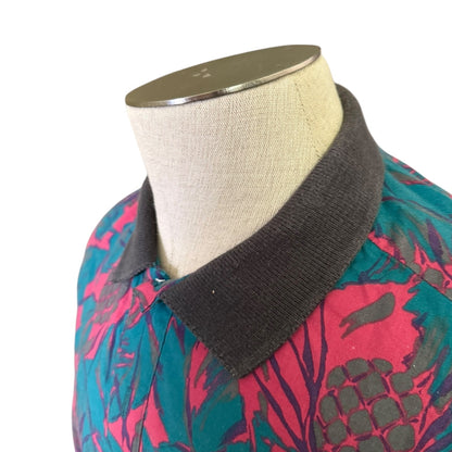 Mannequin wearing a colorful floral-patterned garment with a gray collar.