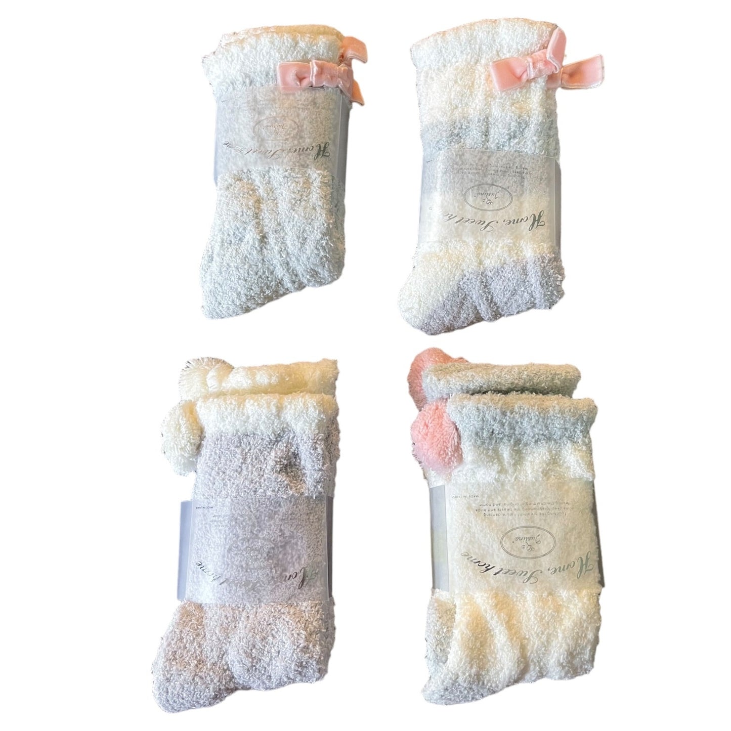 Four pairs of socks with soft texture and pink bows on a white background