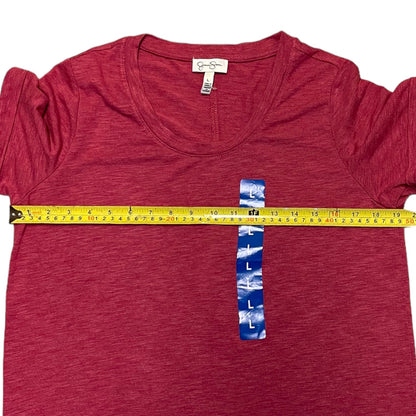 A heathered red short-sleeve dress laid flat on a white background, with a yellow tape measure stretched horizontally across the chest and a blue size label reading L placed vertically at the center to indicate the garment's fit.