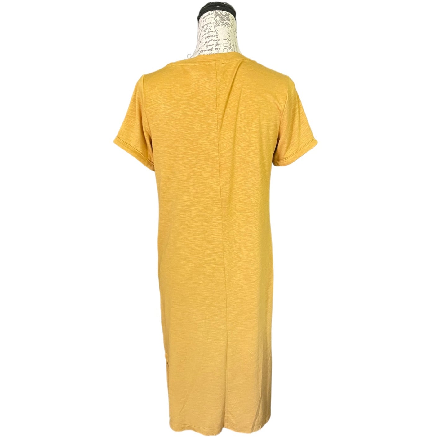 A mustard yellow short-sleeve t-shirt dress displayed on a mannequin from the back, set against a plain white background.