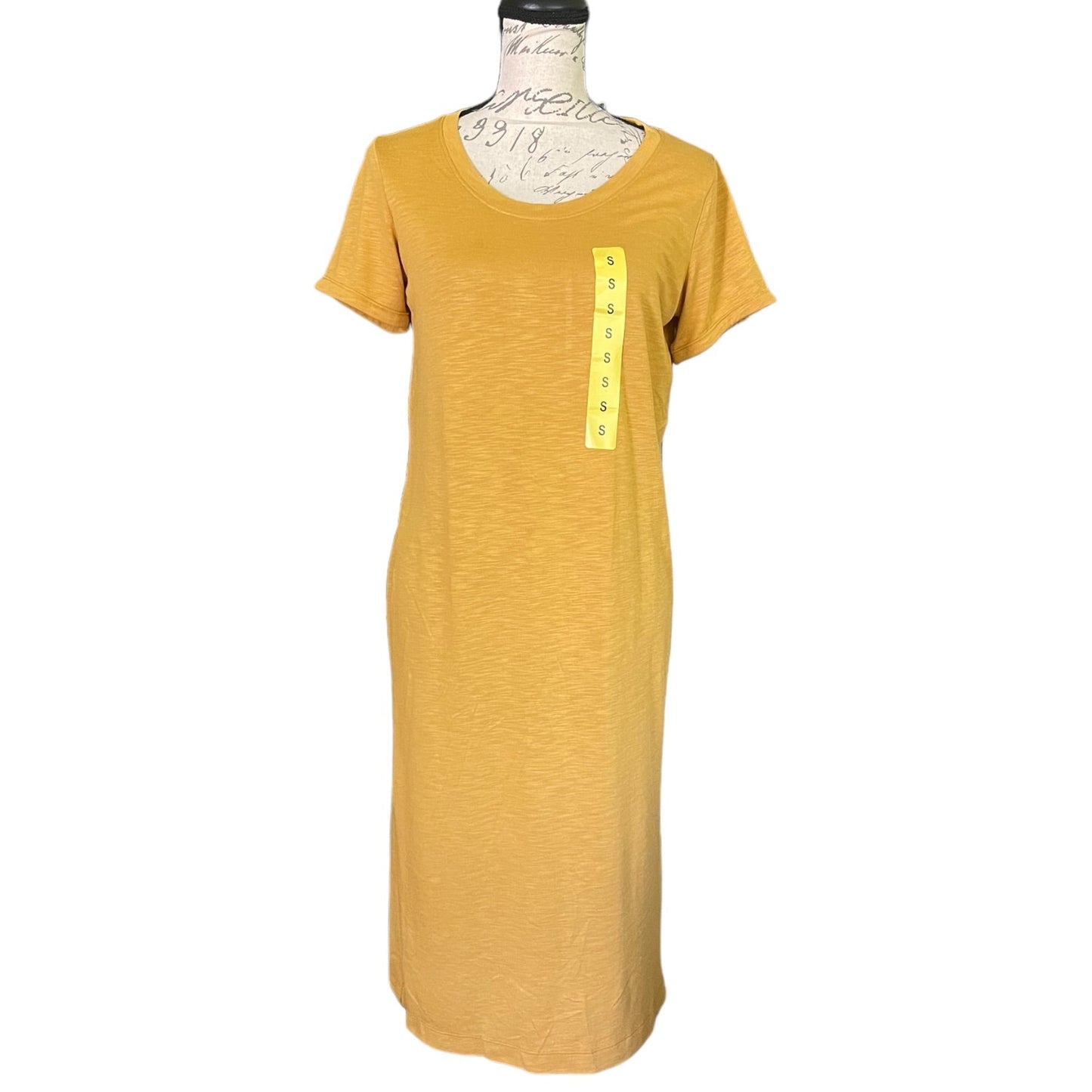 A mustard yellow short-sleeve t-shirt dress displayed on a dress form mannequin against a white background. 