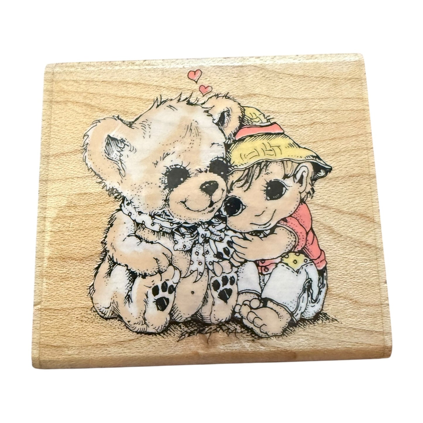 Wooden stamp with a design of two  hugging on a white background
