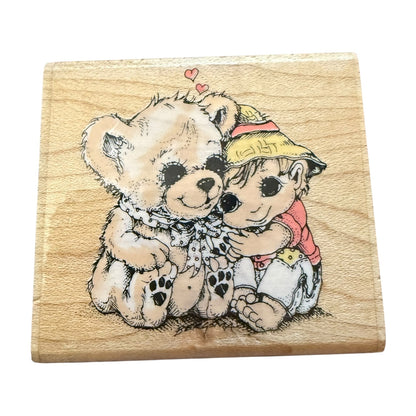 Wooden stamp with a design of two  hugging on a white background