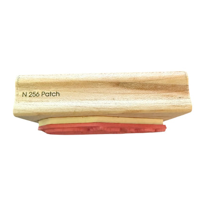Wooden stamp with red rubber stamp N 256 on a white background
