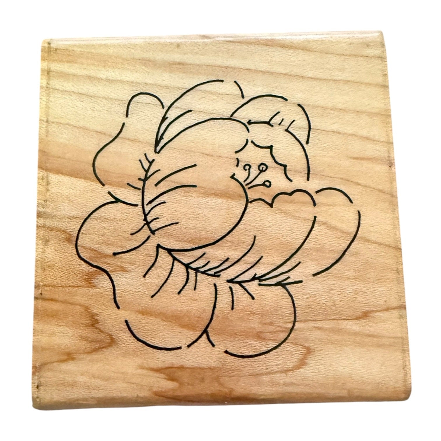 Wooden block with a floral design on it