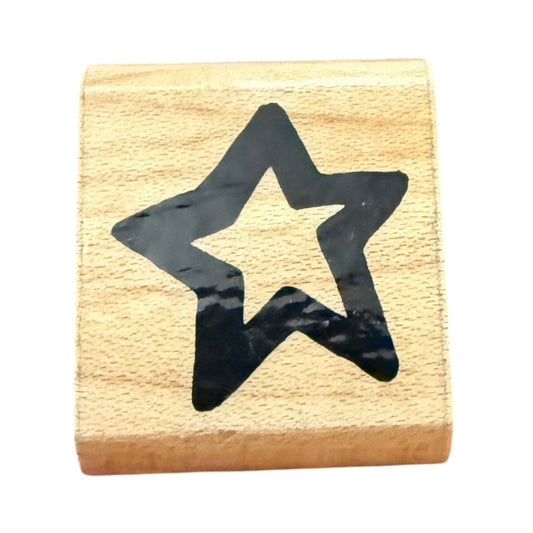 Wooden stamp with a black star design on a white background