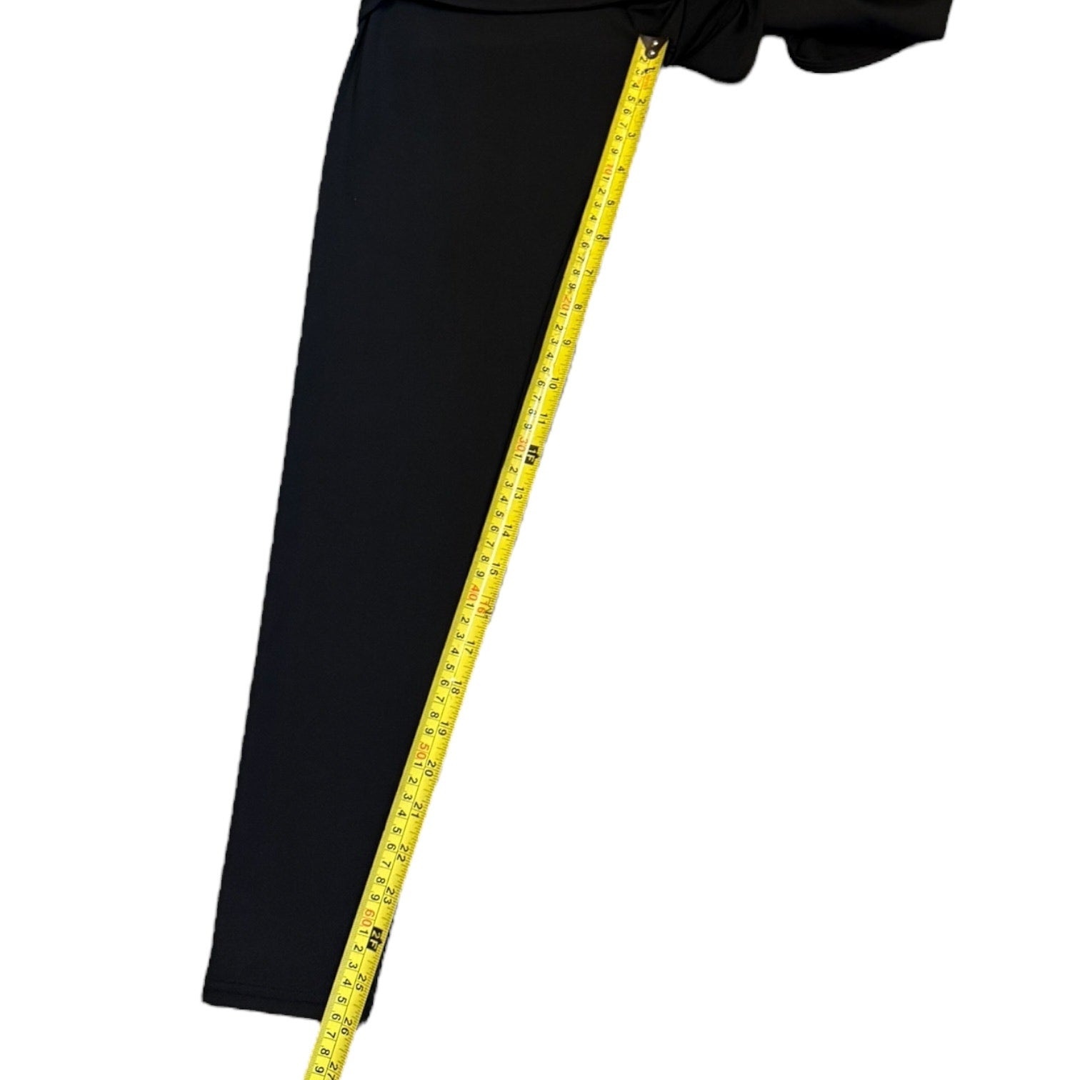 Black pants with a yellow measuring tape on a white background
