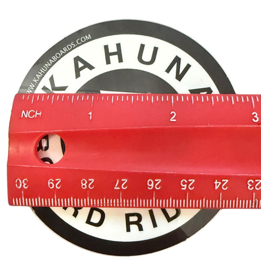 Red ruler with measurement scale 2.8"L against a black and white circular background