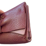 Close-up of leather wallet edges with visible texture on a white background