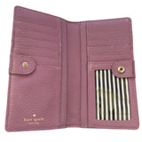 Purple wallet interior with gold accents and 'kate spade' branding on a white background