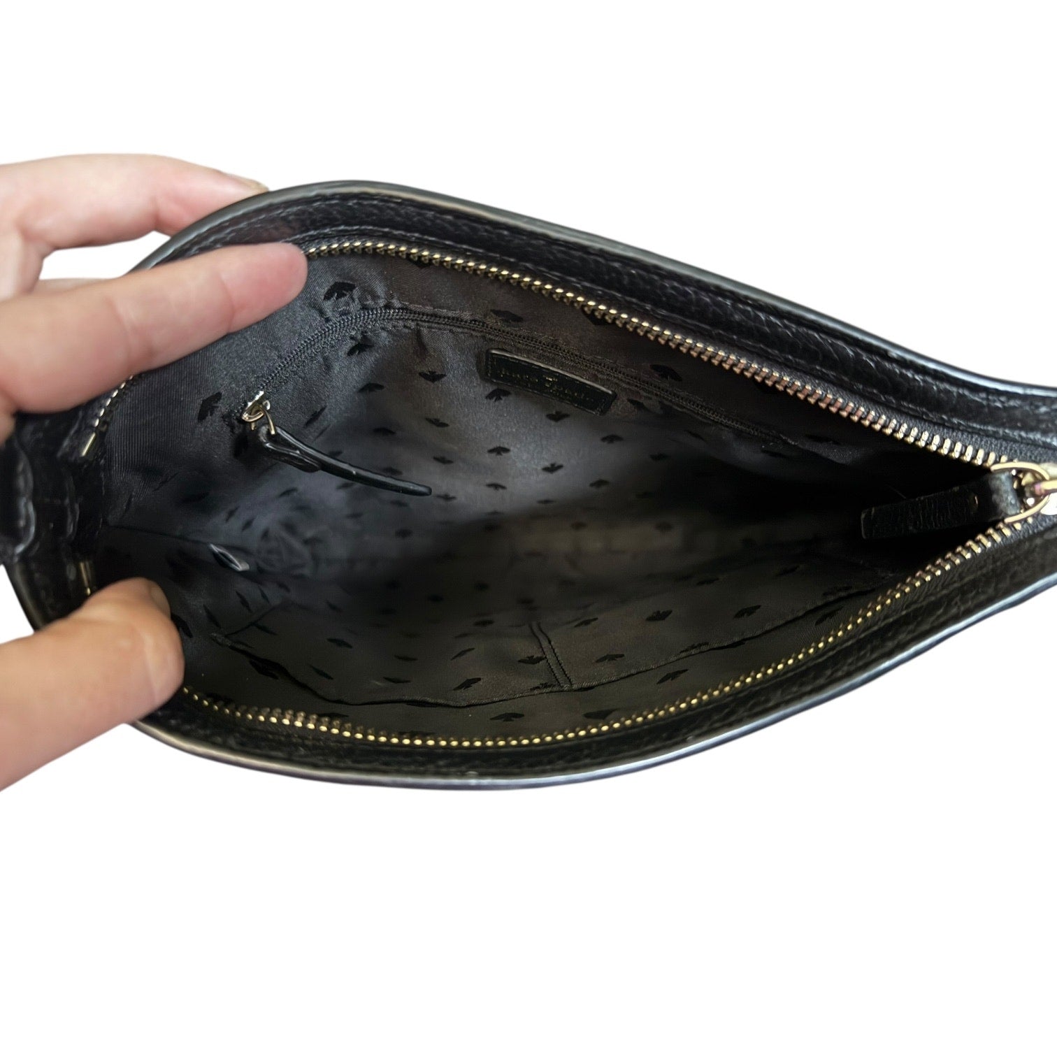 Black handbag interior being held open, 
