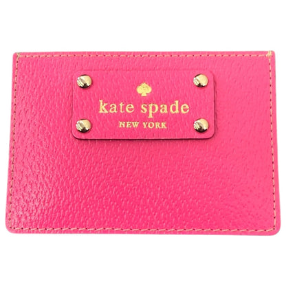 Pink wallet with 'kate spade New York' logo on a white background