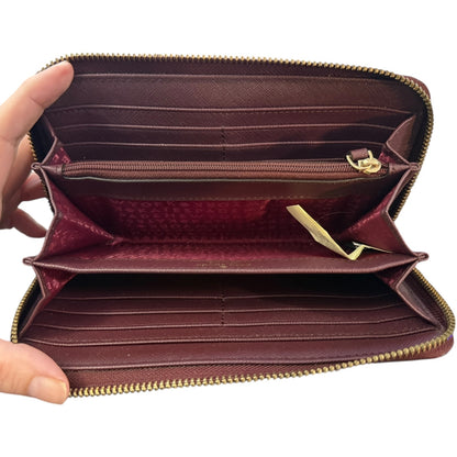 Open leather wallet with gold zipper on a white background