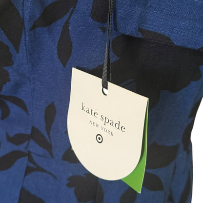 Close-up of a blue and black floral patterned garment with a hanging Kate Spade New York tag.