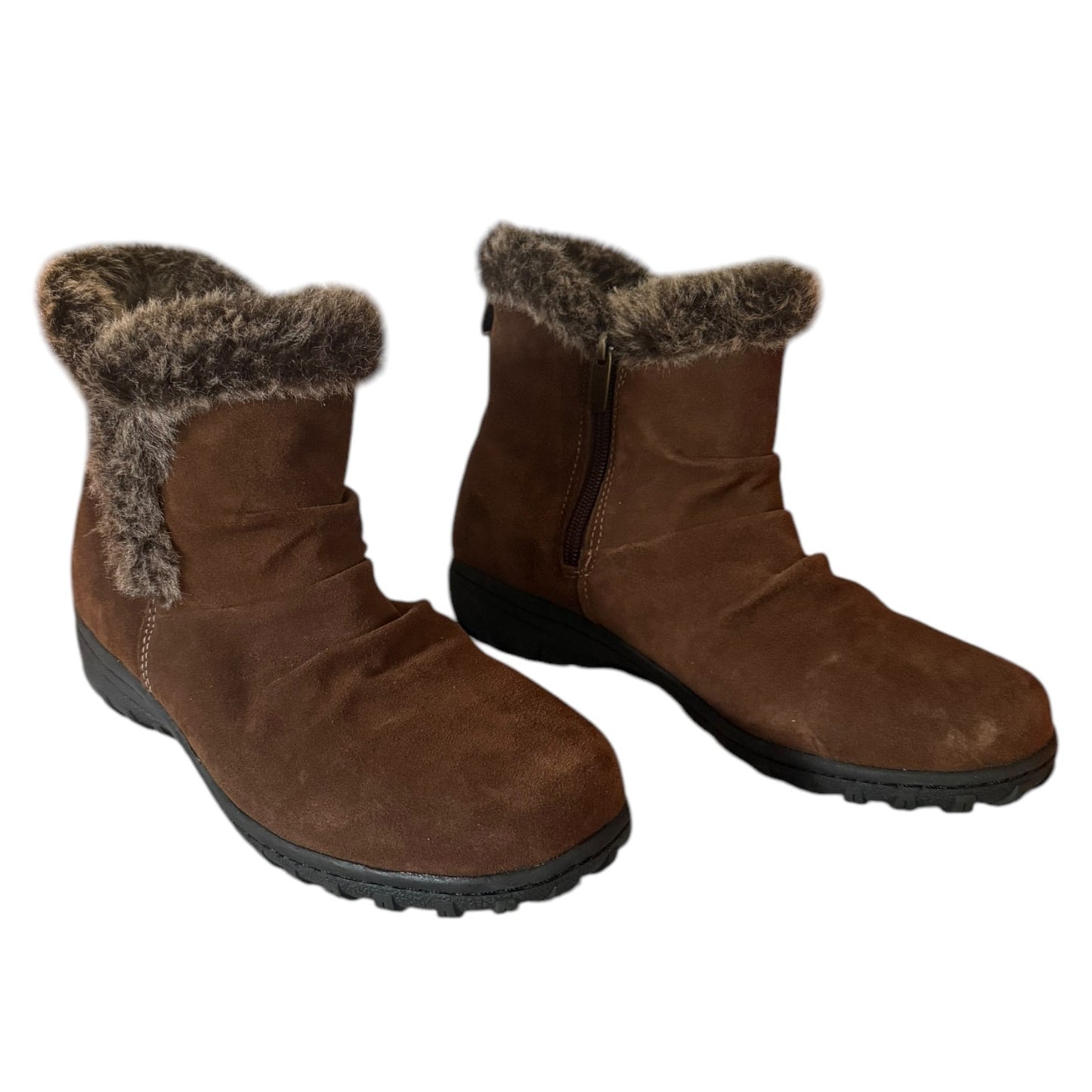 Pair of brown winter boots with fur trim on a white background