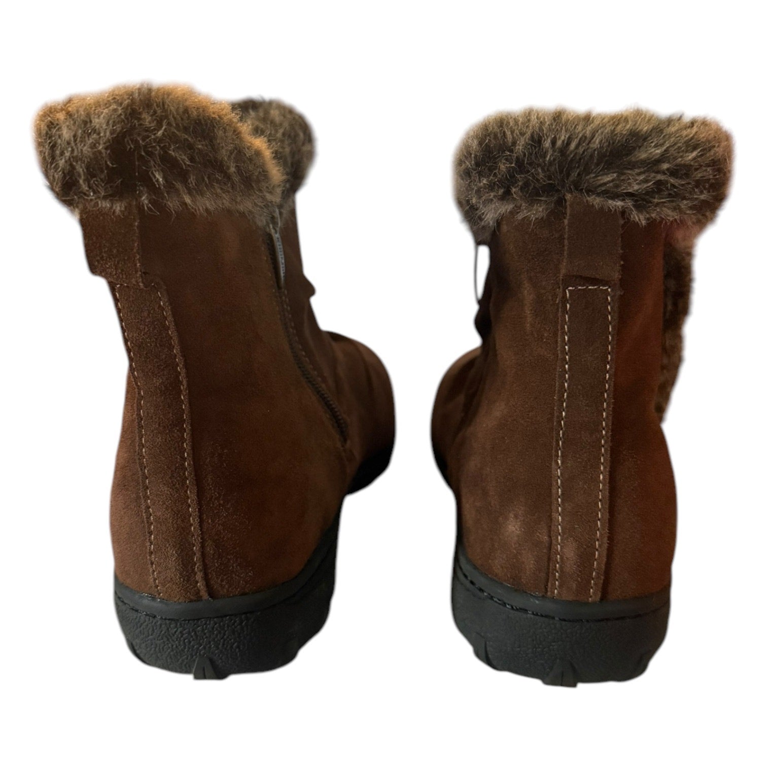 Back of a Pair of brown boots with fur trim on a white background