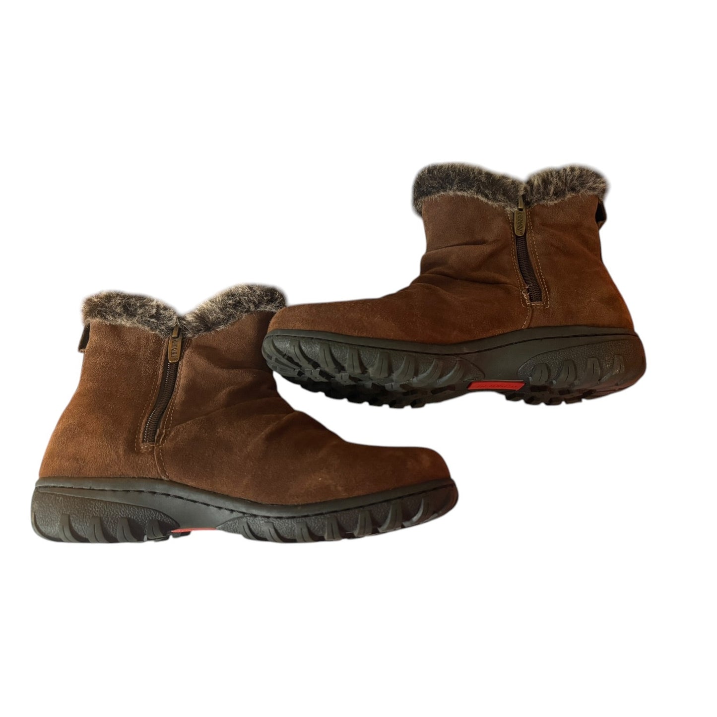 Side of a Pair of brown winter boots with fur trim on a white background