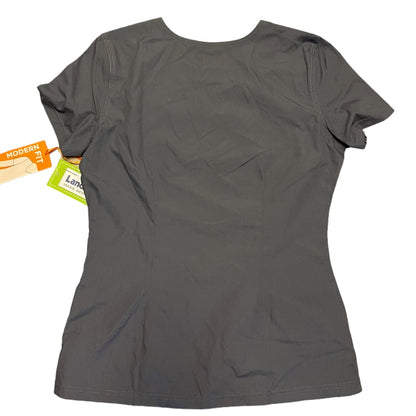 A dark gray short-sleeve shirt shown from the back, with a hangtag still attached on the left side, photographed against a plain white background.