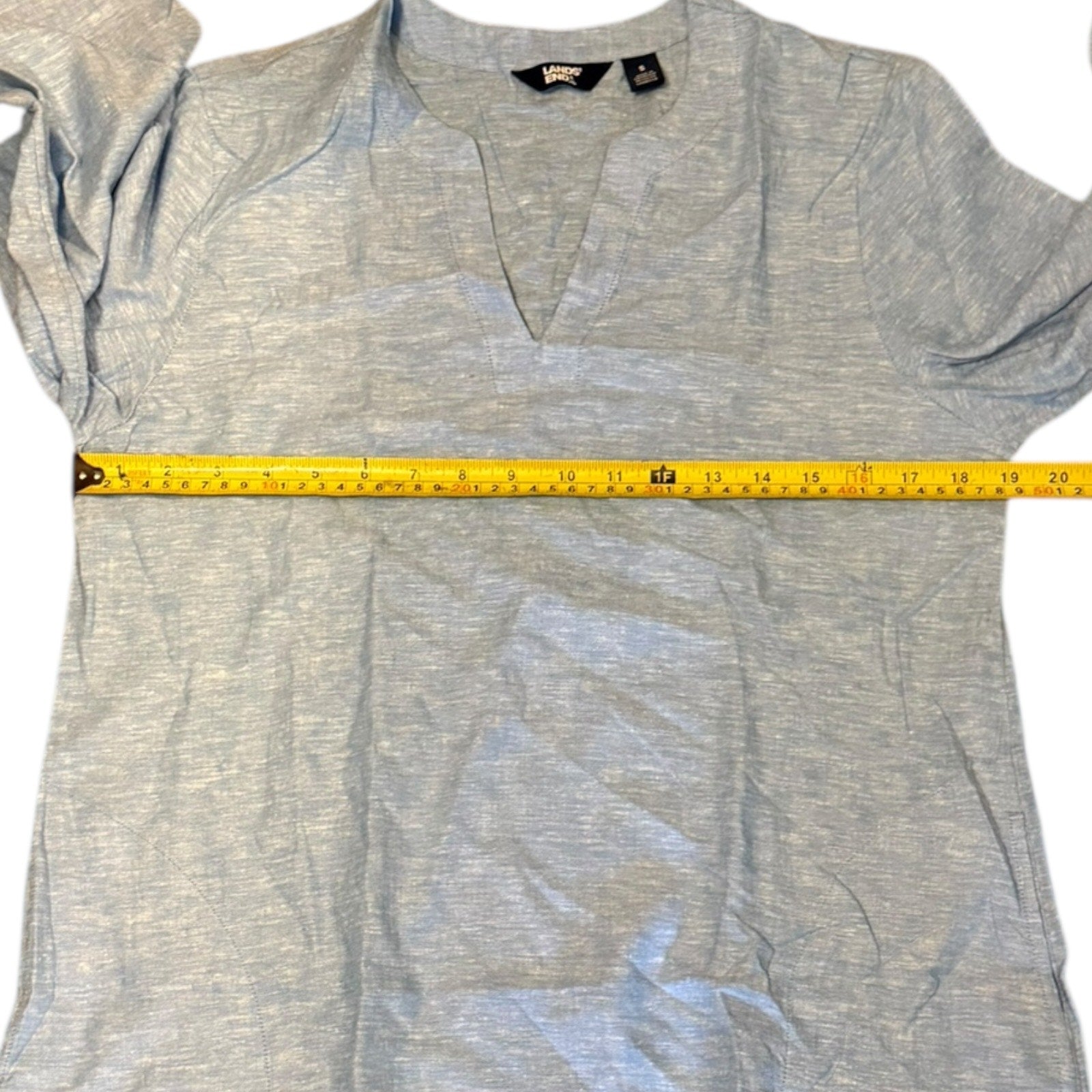 Blue shirt with a measuring tape on a white background
