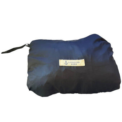 Windbreaker rolled into pouch with a visible brand label on a white background