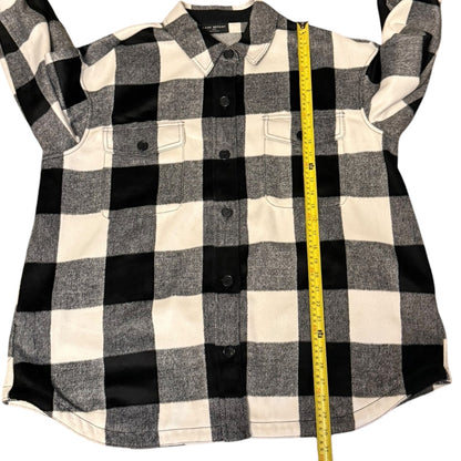 Black and white checkered shirt with a measuring tape on a white background