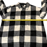 Black and white checkered shirt with a measuring tape for size reference on a white background