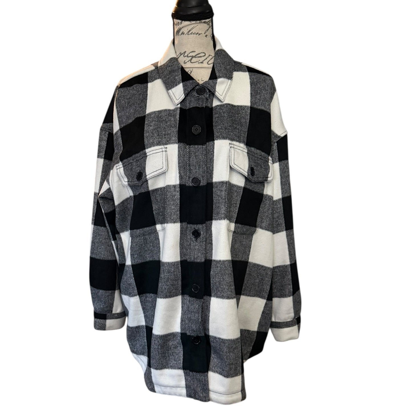 Front of Black and white checkered flannel shacket on a mannequin against a white background