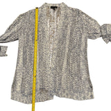 Blue cardigan with a measuring tape on a white background