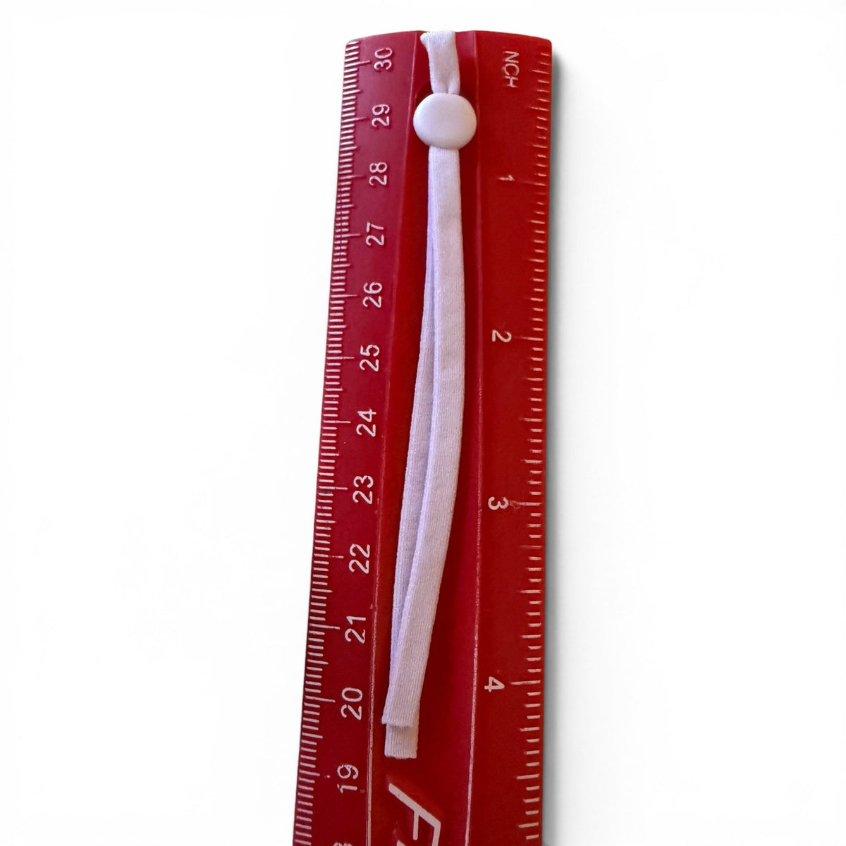 Red ruler with a purple pull tab on a white background