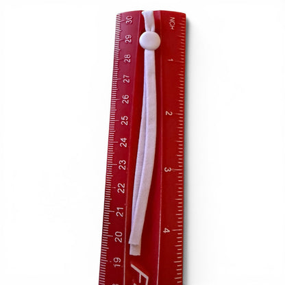 Red ruler with a purple pull tab on a white background