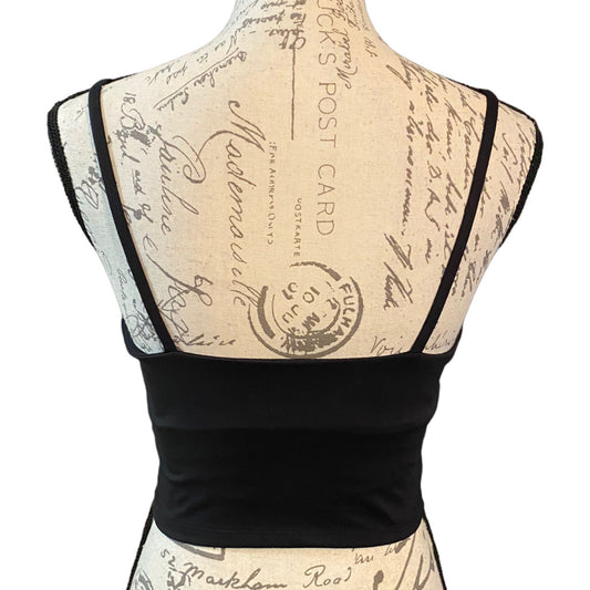 Back of Black tank bra with thin straps on a mannequin with a vintage-style script background