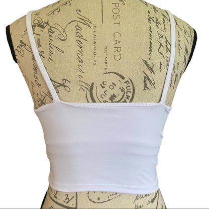 Back of white fitness tank top displayed on a vintage-style paper dress form mannequin against a white background.