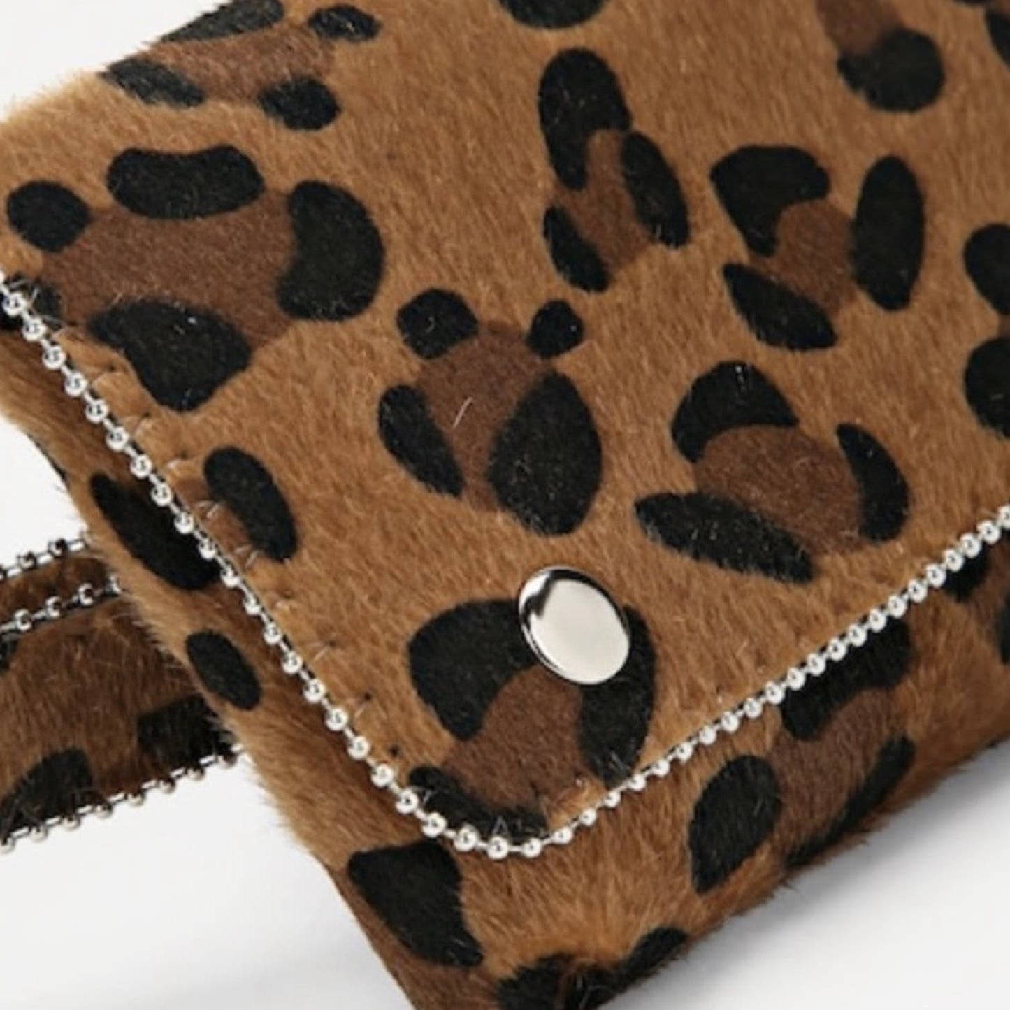 Leopard print bag with a chain detail on a white background